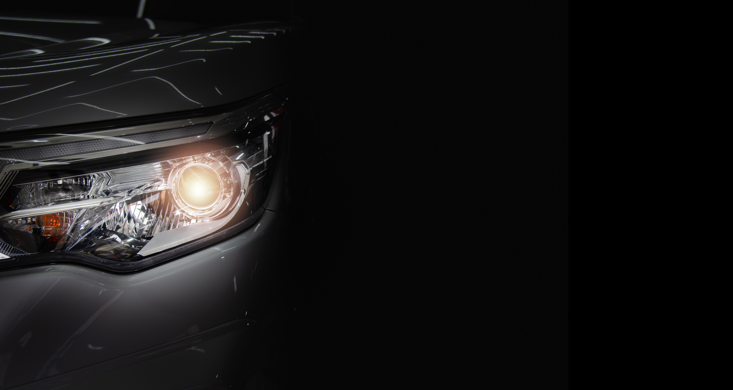 Headlight of an Automobile on Dark Background